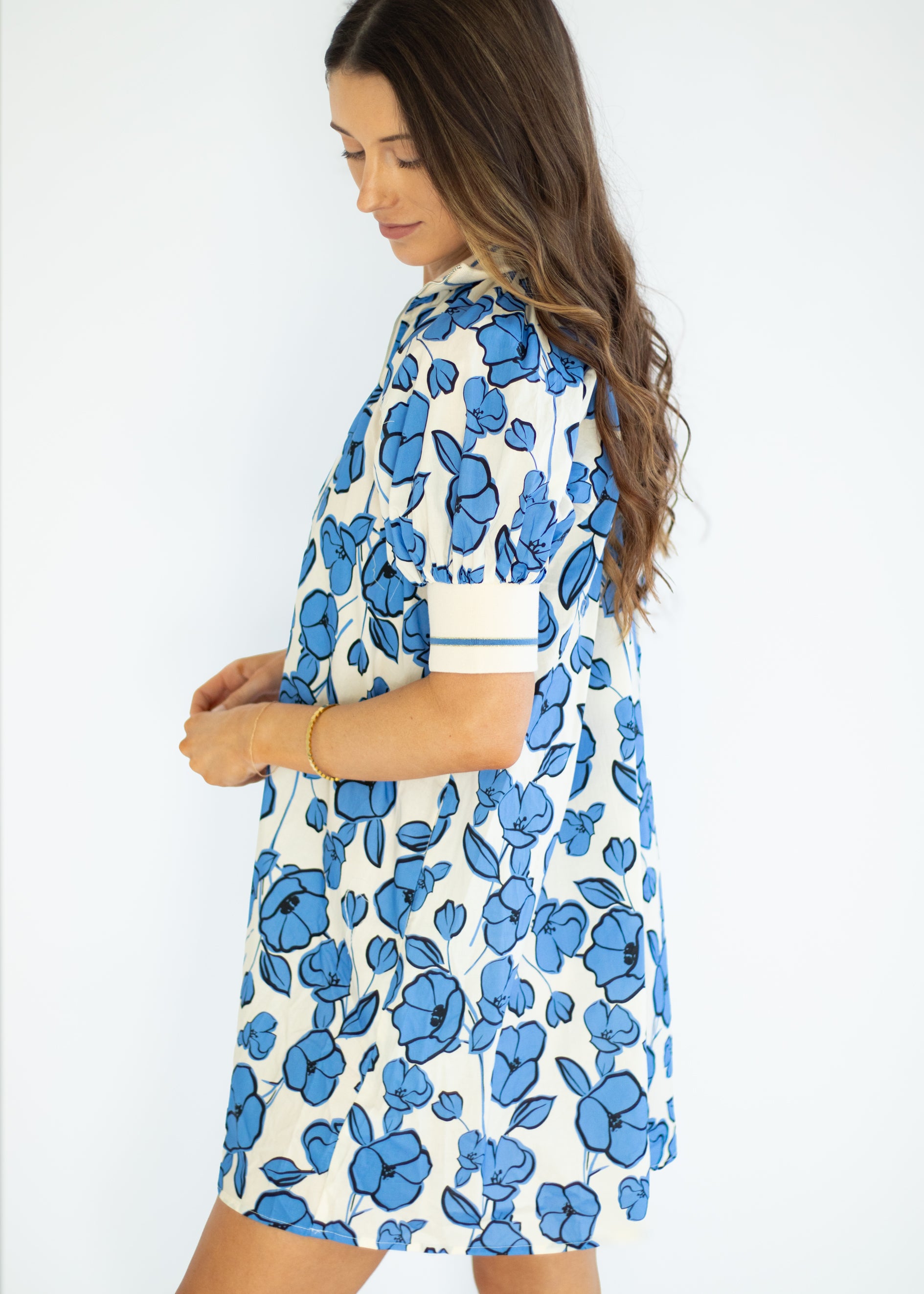 Woman wearing a blue floral dress on a white background