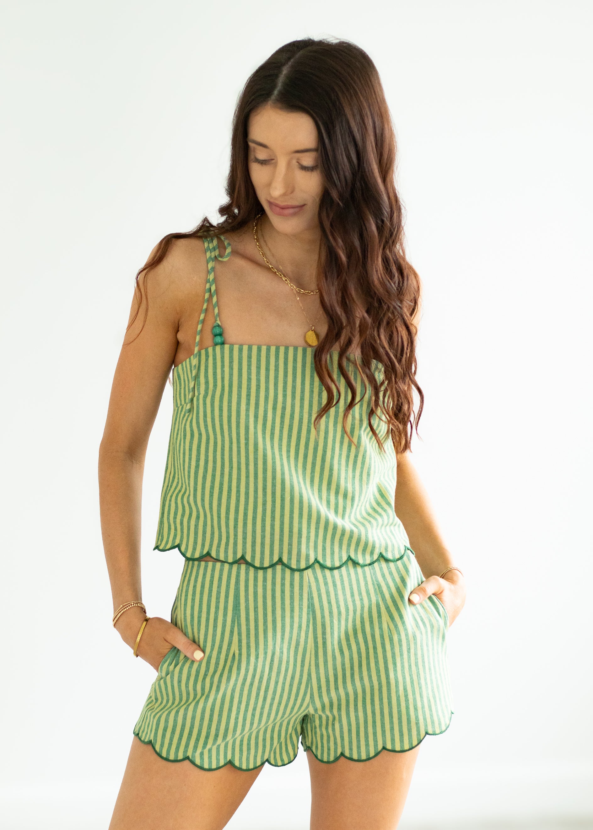 Woman wearing a green striped set on a white background