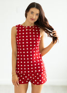 Woman wearing a red polka dot set on a white background
