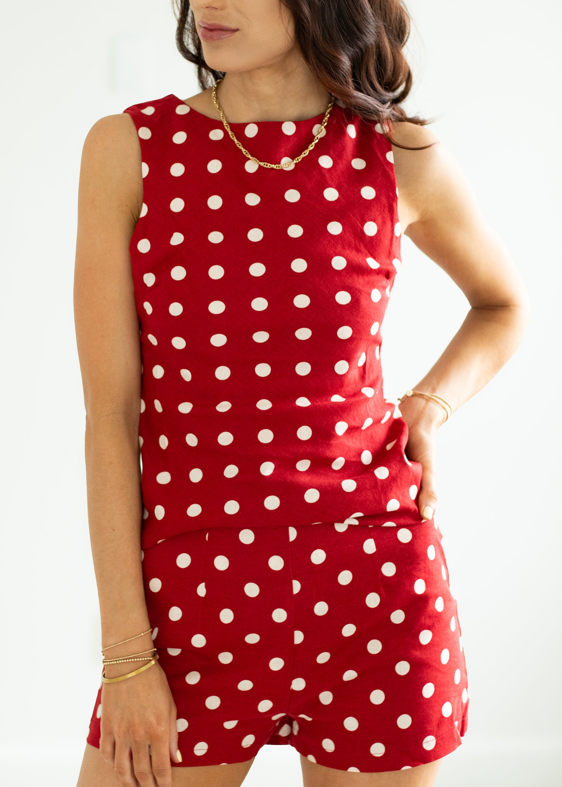 Woman wearing a red polka dot set on a white background
