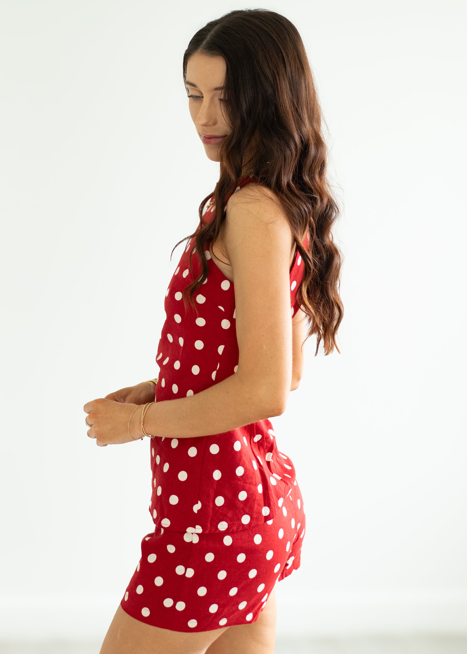 Woman wearing a red polka dot set on a white background