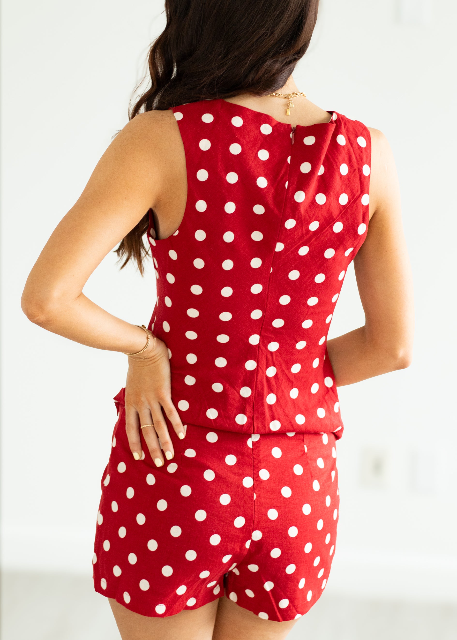 Woman wearing a red polka dot set on a white background