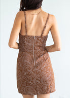 Brown patterned dress with thin straps on a white background
