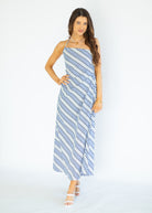 Woman wearing a blue and white striped dress on a white background