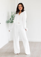 Woman wearing a white outfit in a minimalistic setting