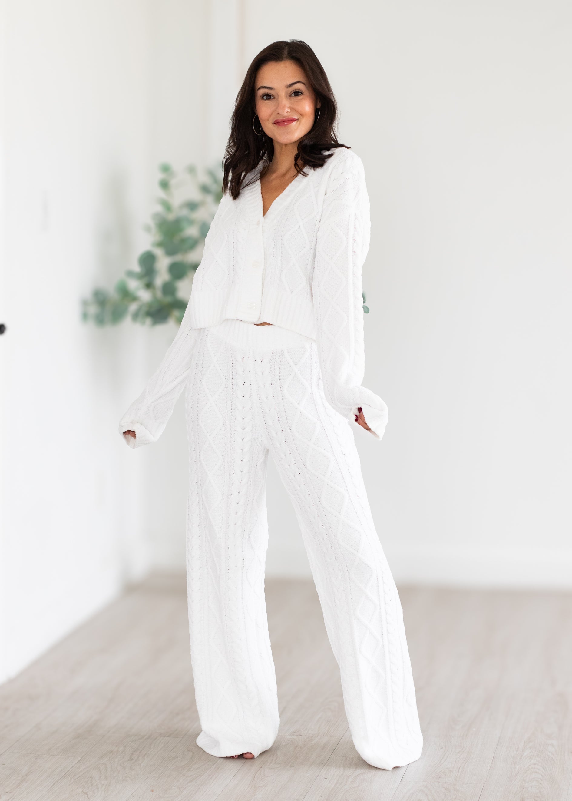 Woman wearing a white outfit in a minimalistic setting