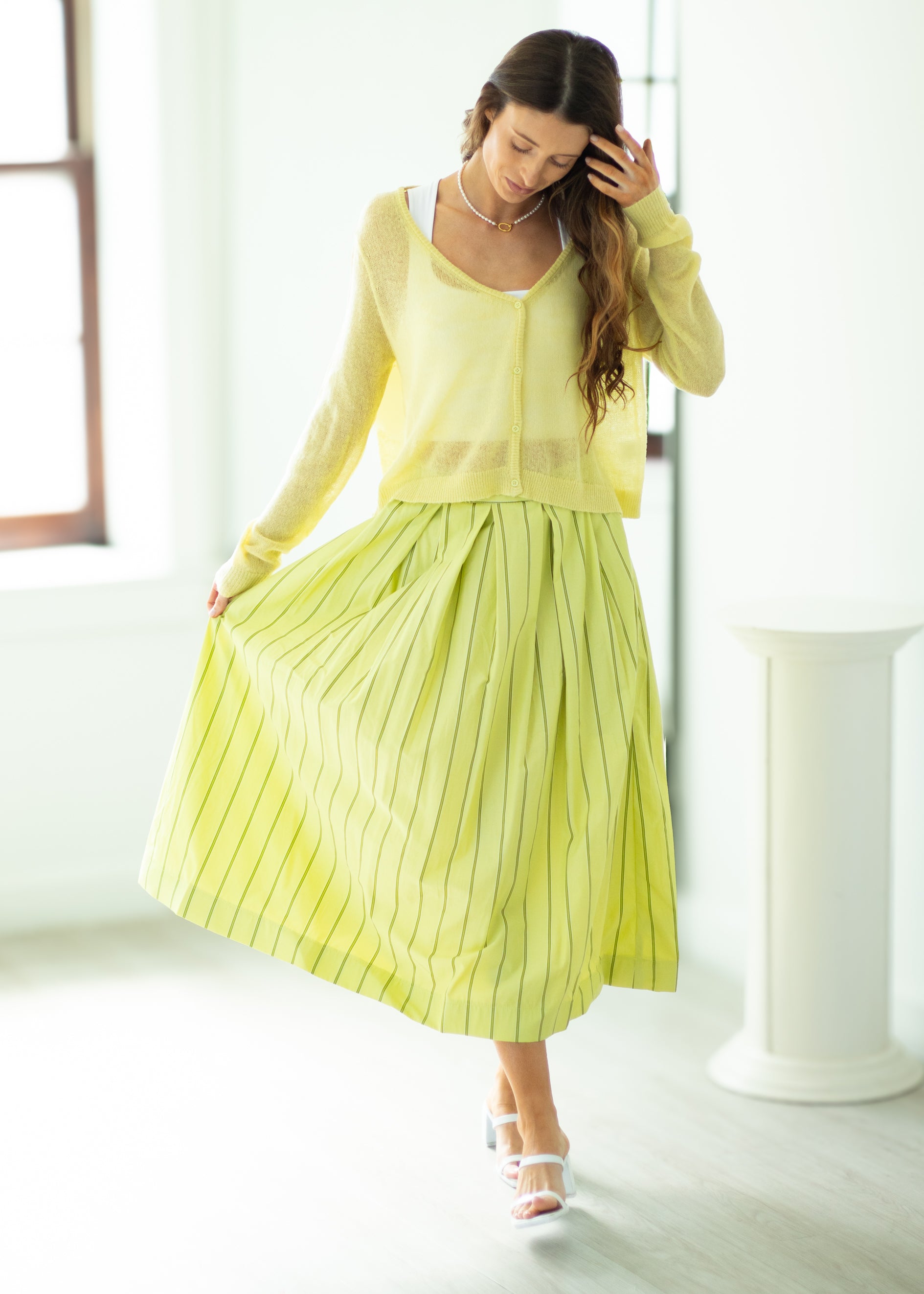 Woman wearing a yellow outfit in a bright room