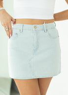 Light blue striped skirt worn by a person on a white background