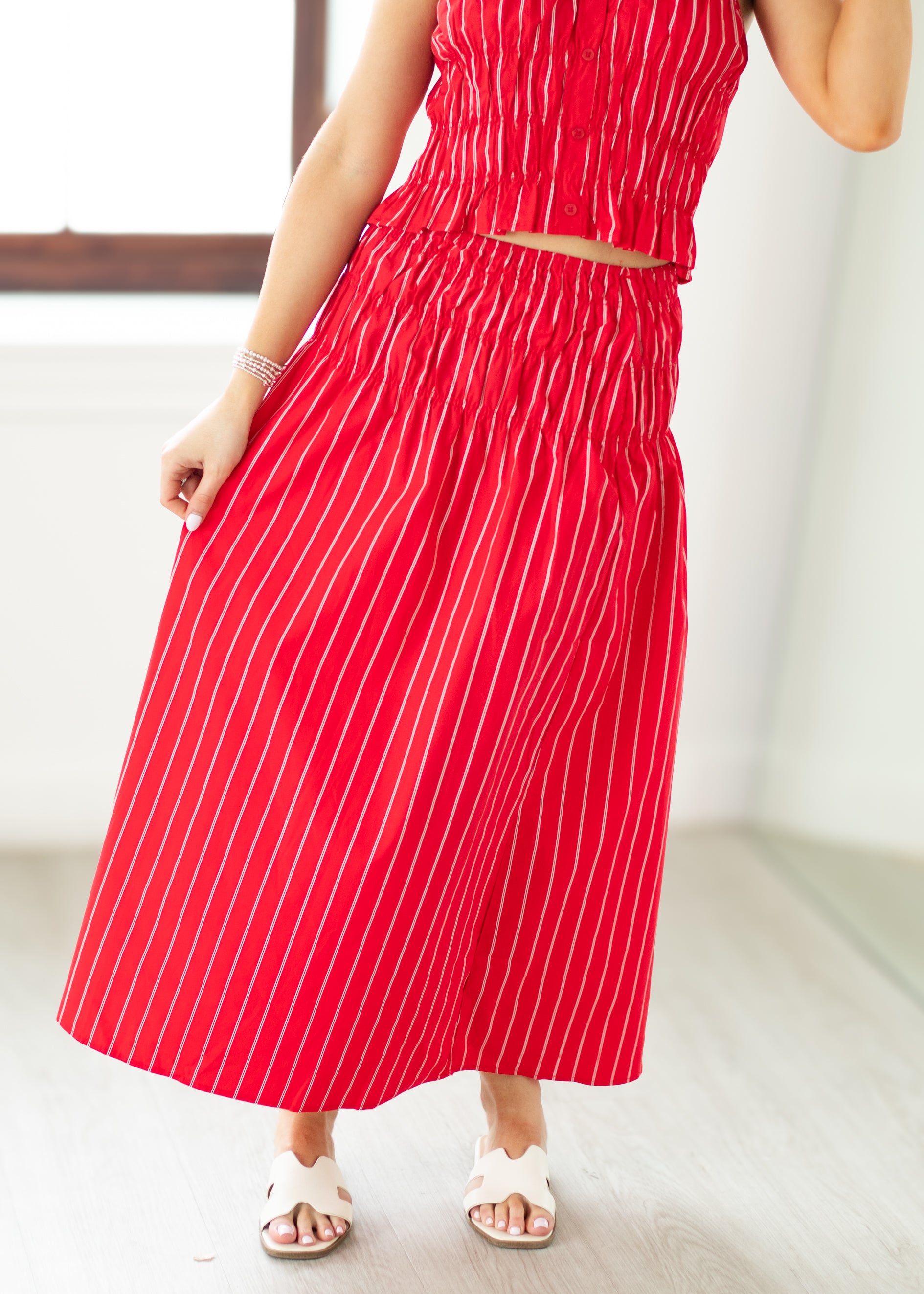 Red and white striped dress worn by a person indoors.