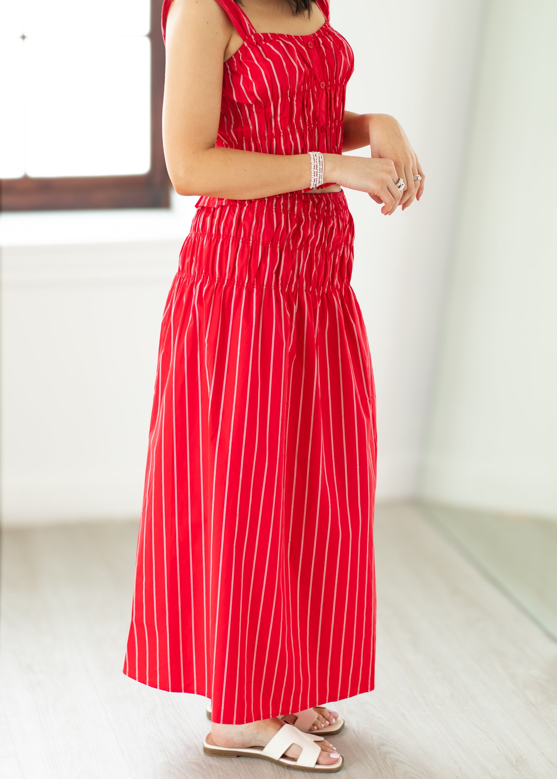 Red striped dress worn by a person on a white background