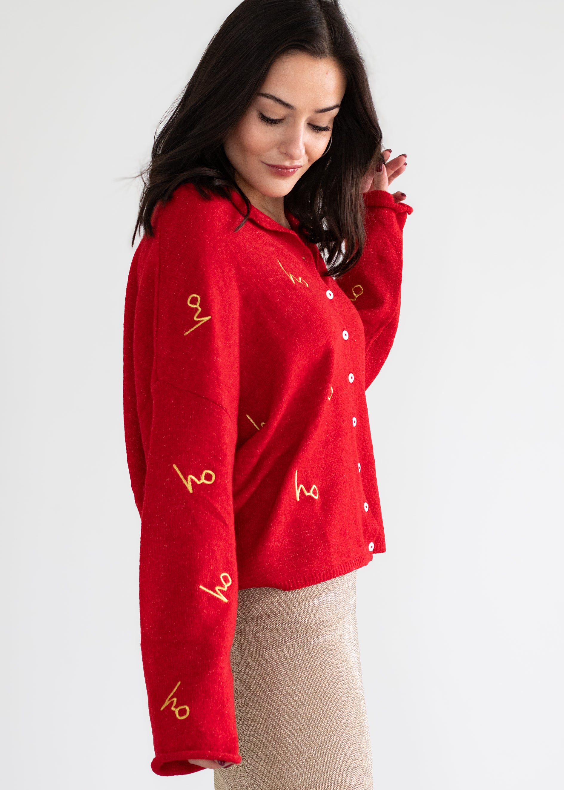 Woman wearing a red sweater with yellow text on a white background