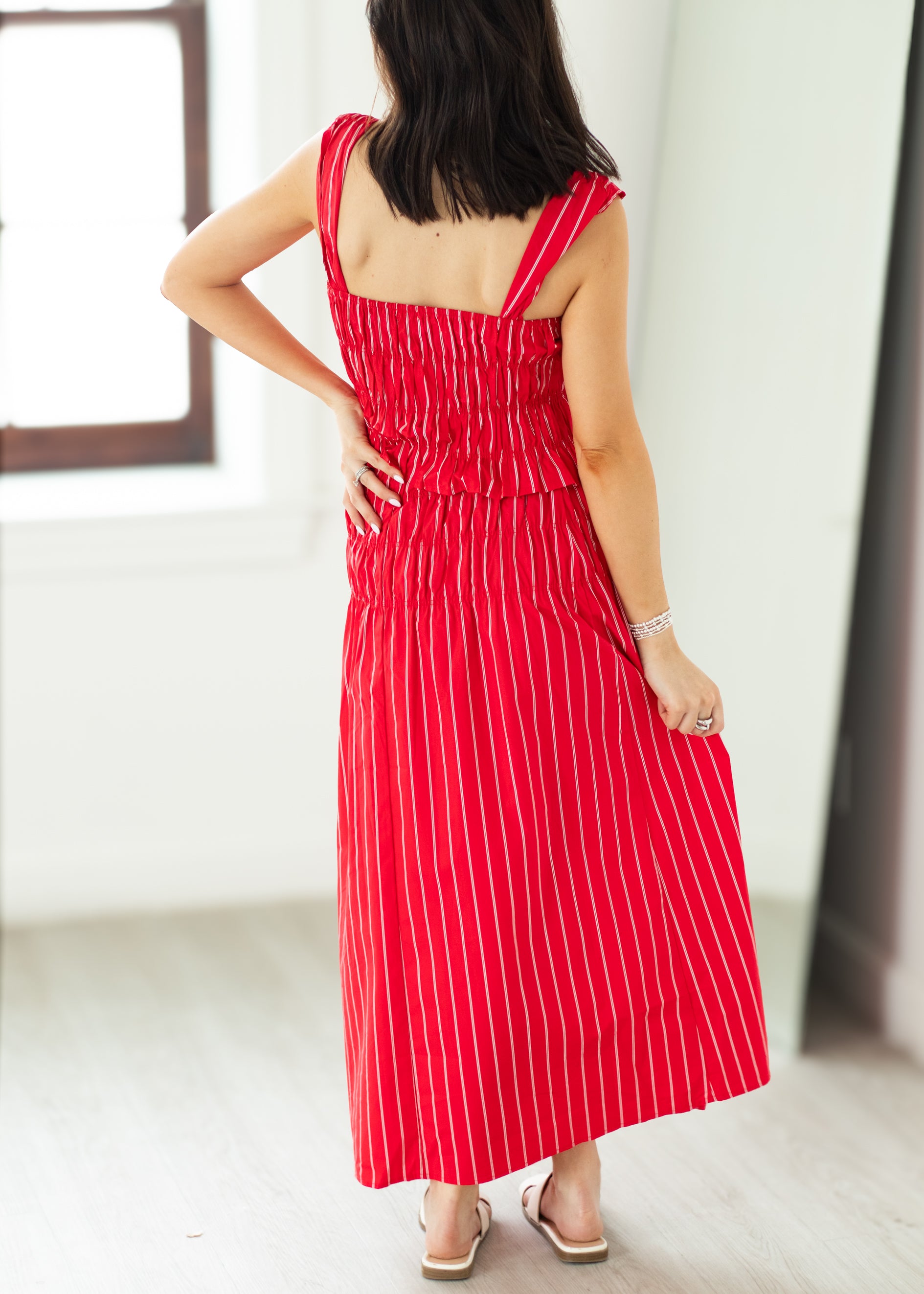 Woman wearing a red and white striped dress with a blurred background