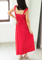 Woman wearing a red and white striped dress with a blurred background