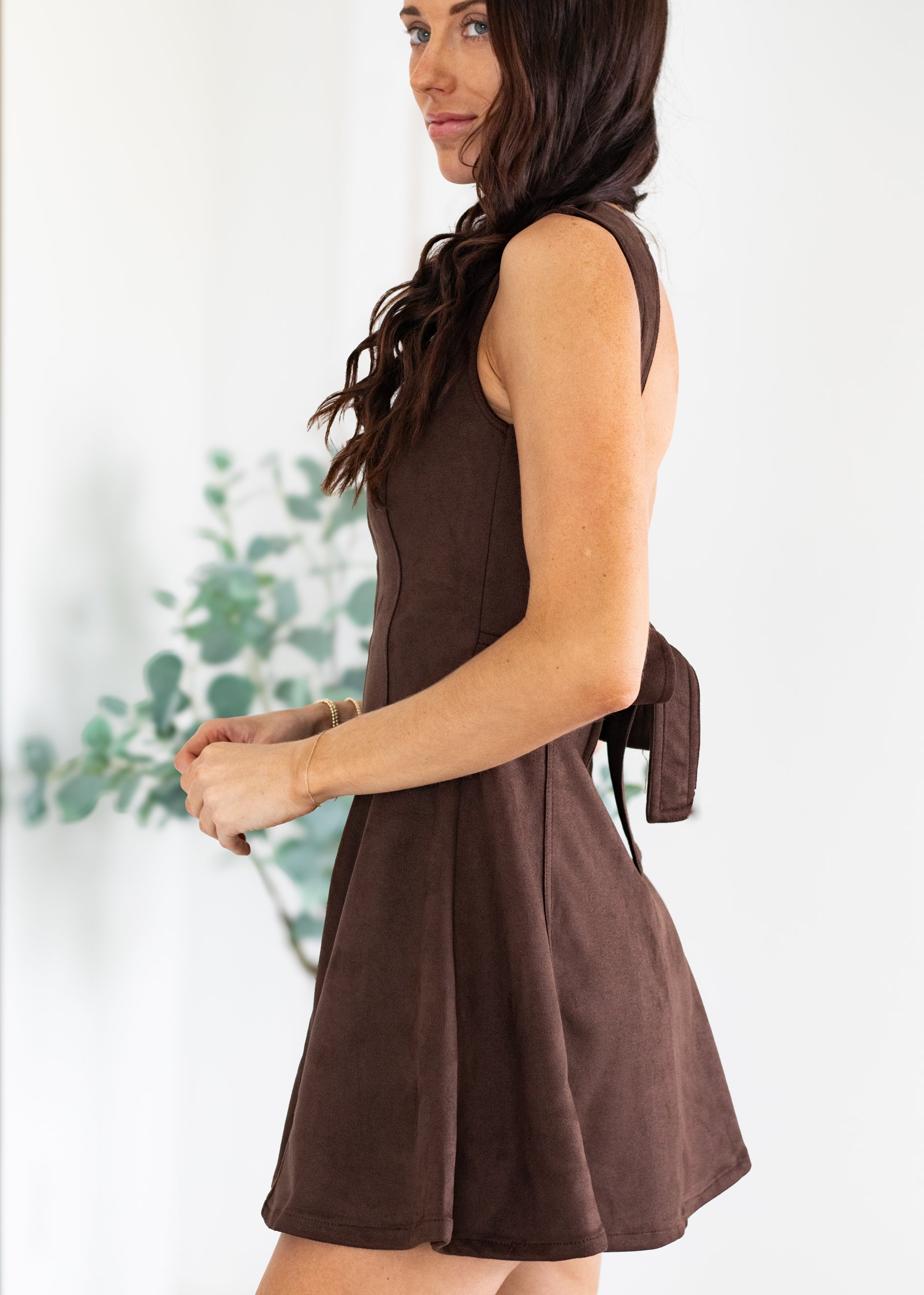 Woman wearing a brown dress with a blurred background