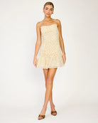 Woman wearing a light-colored dress on a white background
