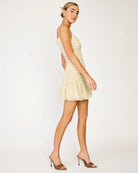 Woman wearing a beige floral dress on a white background