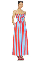 Woman wearing a red and blue striped dress on a white background