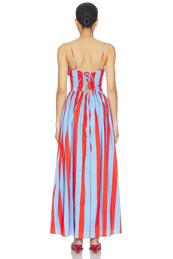 Woman wearing a colorful striped dress on a white background