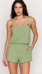 Woman wearing a green striped set on a white background