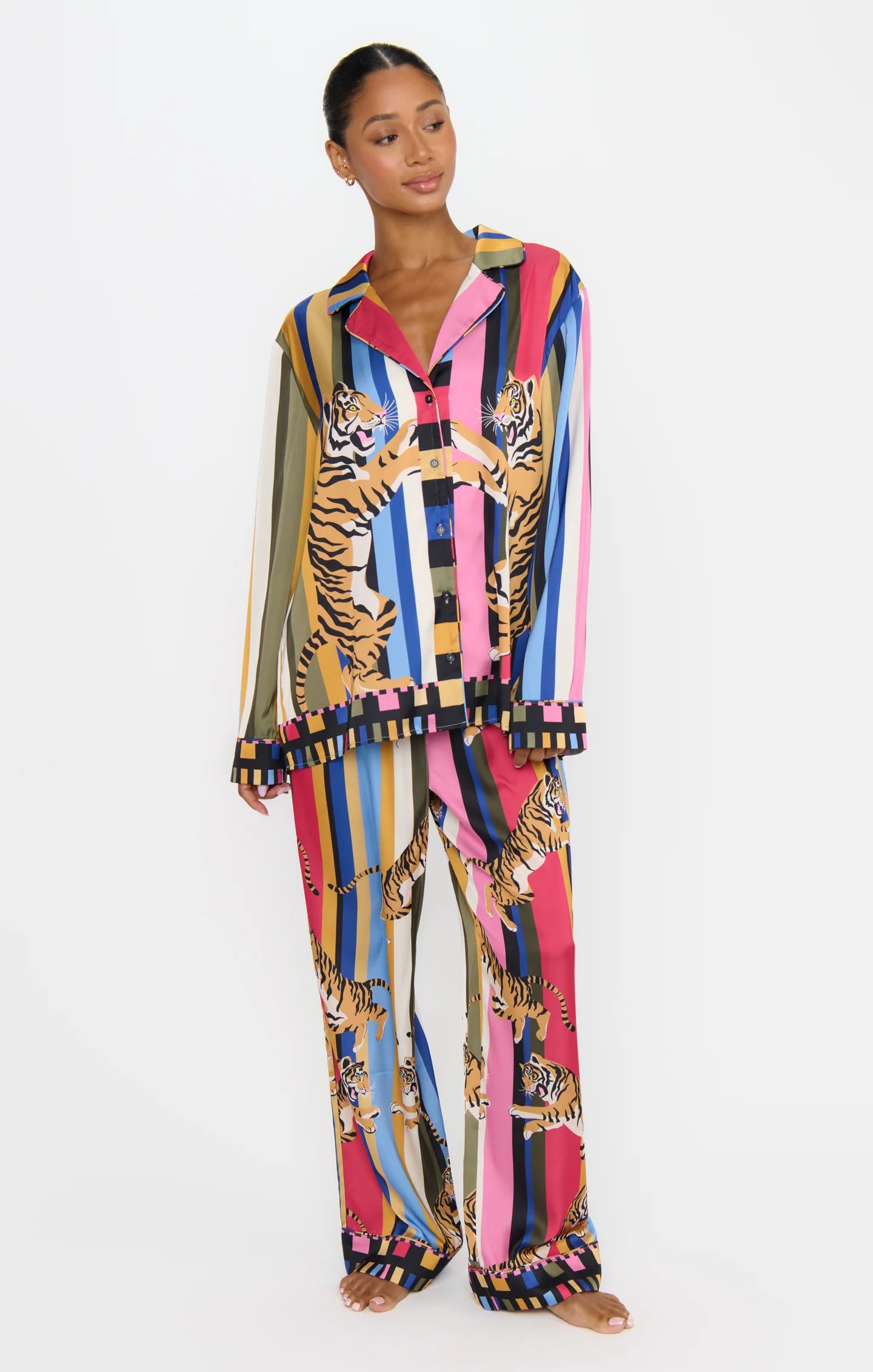 Woman wearing a colorful outfit with tiger patterns on a white background