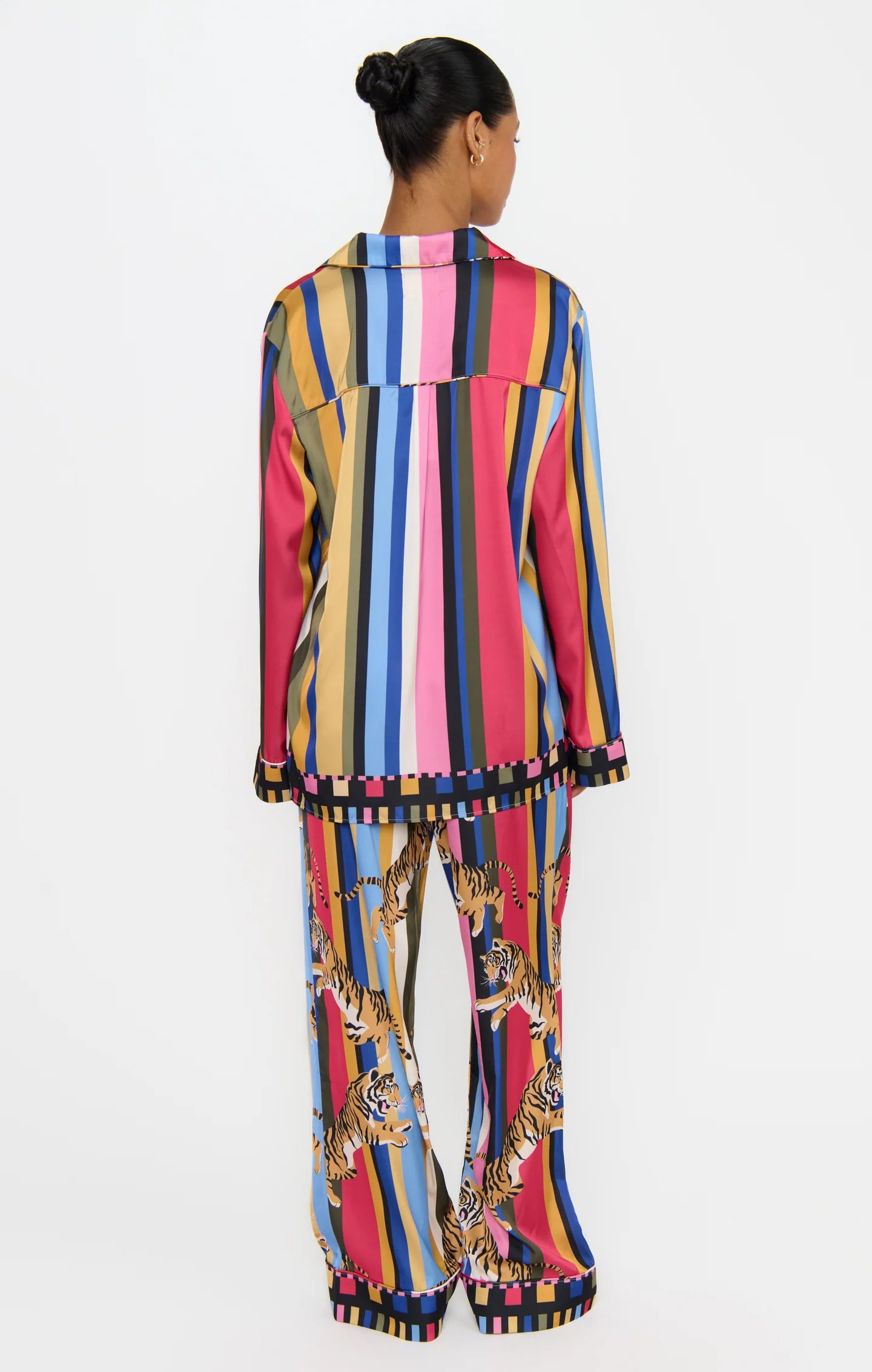 Person wearing a colorful striped outfit with a patterned design on a white background