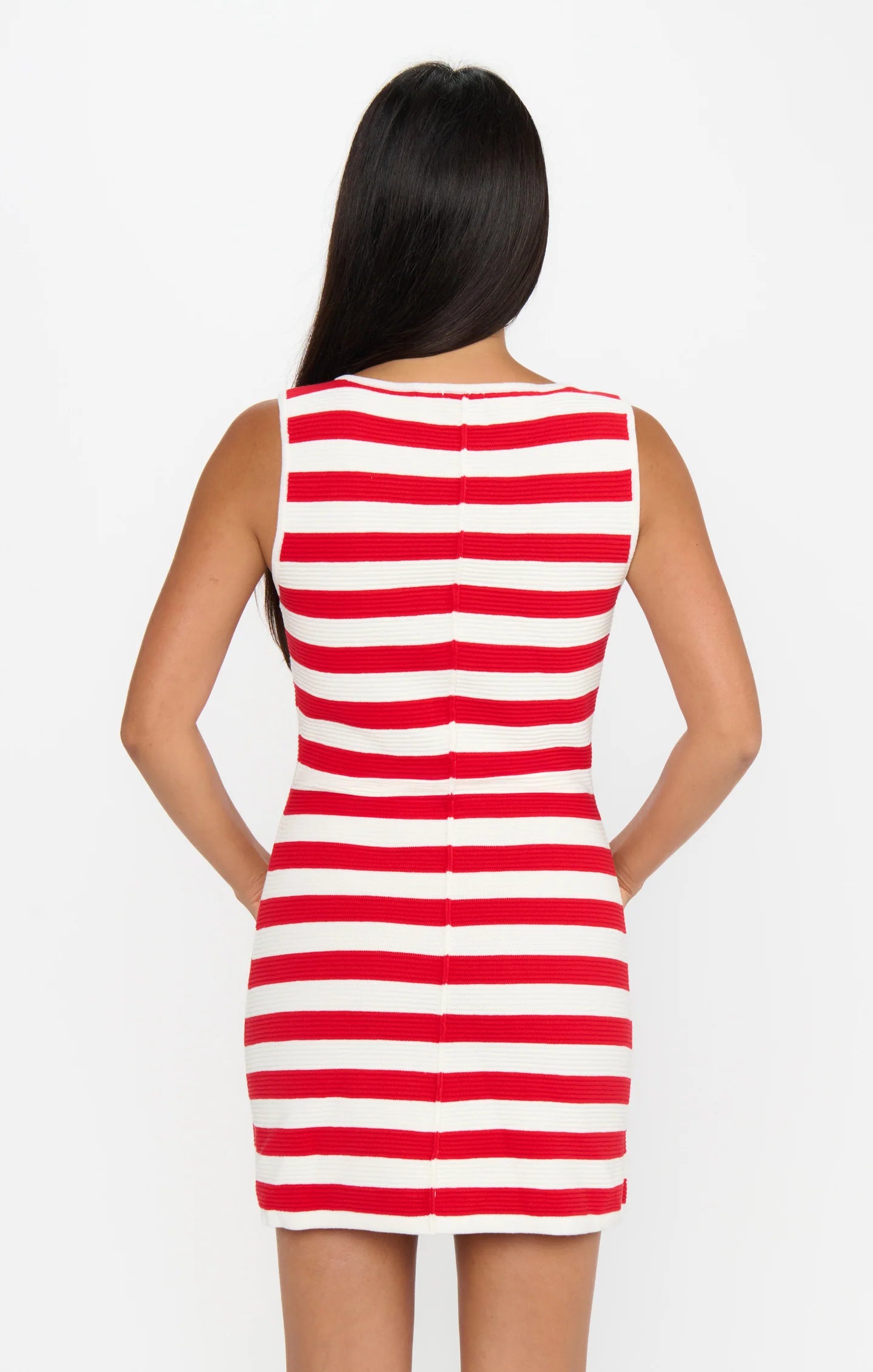 Red and white striped dress worn by a person on a white background