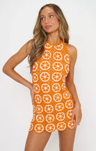 Woman wearing an orange dress on a white background