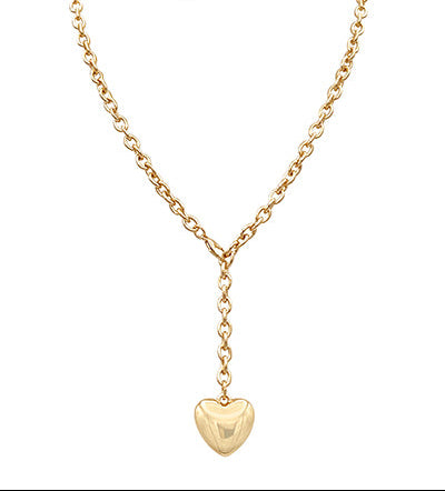 Gold necklace with a heart pendant on a white background