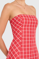 Red and white checkered strapless dress on a plain background