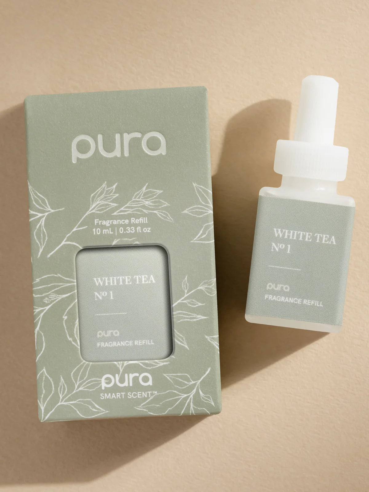 Pura White Tea fragrance refill bottle and packaging on a beige background