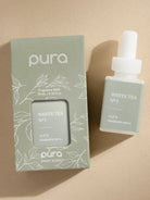 Pura White Tea fragrance refill bottle and packaging on a beige background