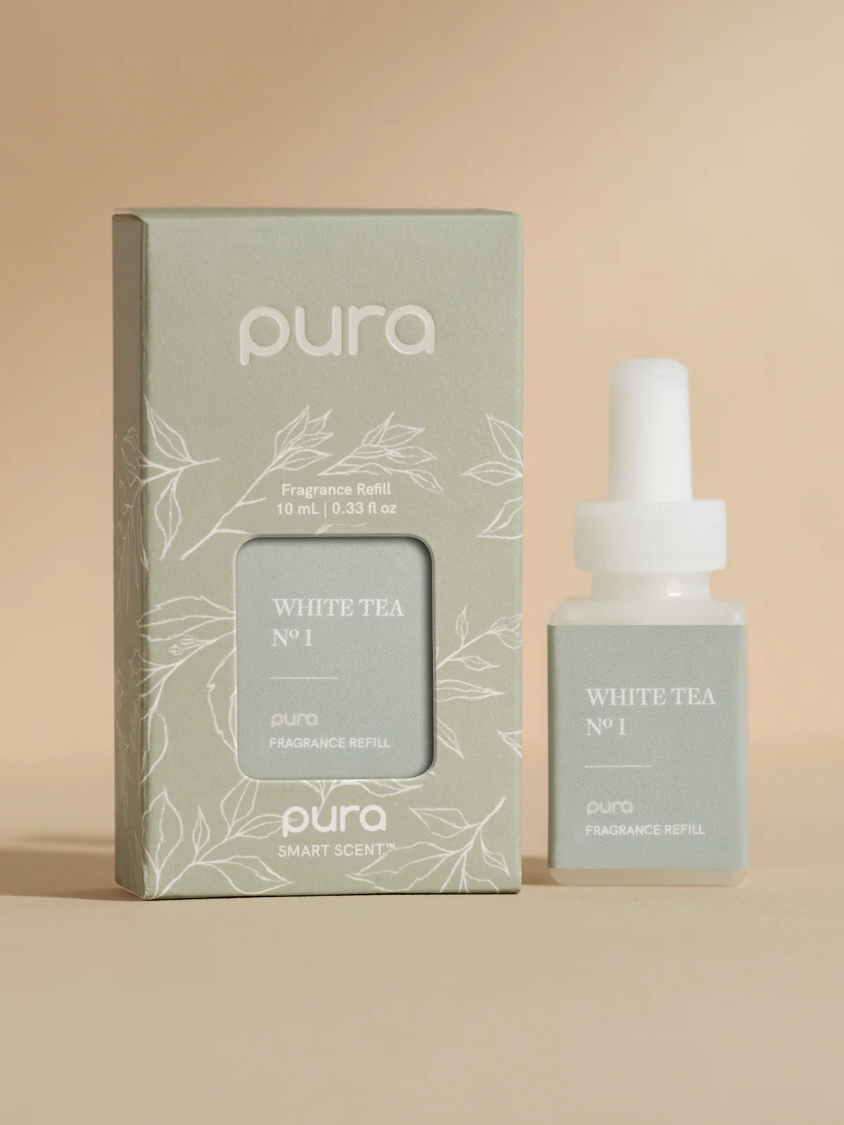 Pura white tea fragrance bottle and packaging on a beige background