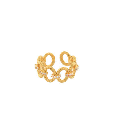Gold ring with intricate design on a white background