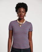 Woman wearing a striped shirt with a plain background