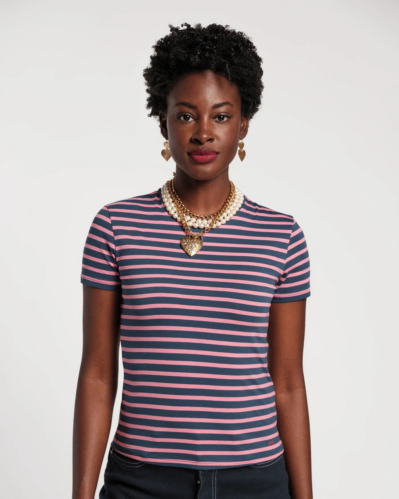 Woman wearing a striped shirt with a plain background