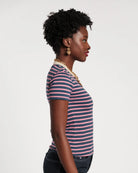 Woman wearing a striped shirt with a plain background