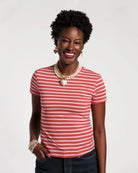 Woman wearing a red and blue striped shirt with a plain background