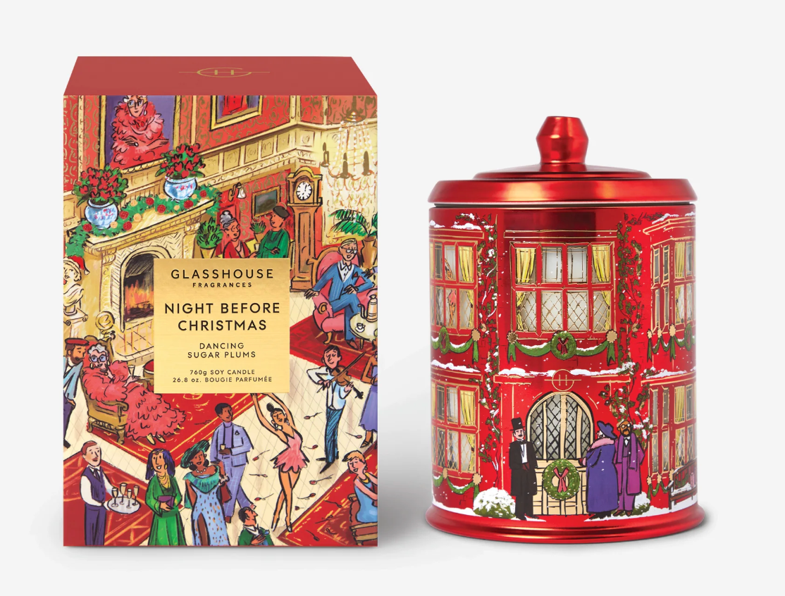 A red glass jar with a matching lid and a matching illustrated box, both featuring a festive Christmas city street scene with people and holiday decorations. The box reads 'GLASSHOUSE FANTASY Night Before Christmas Dancing Sugar Floss.