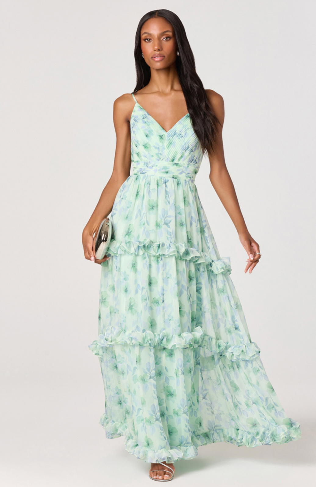 Woman wearing a green floral dress on a white background
