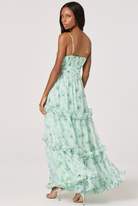 Woman wearing a green floral dress on a white background