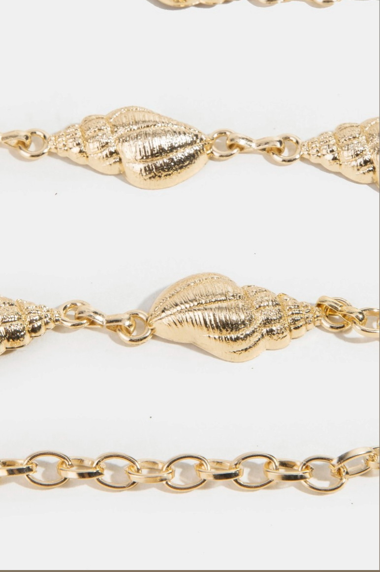 Gold shell and chain belt on a white background