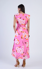 Woman wearing a pink floral dress on a white background