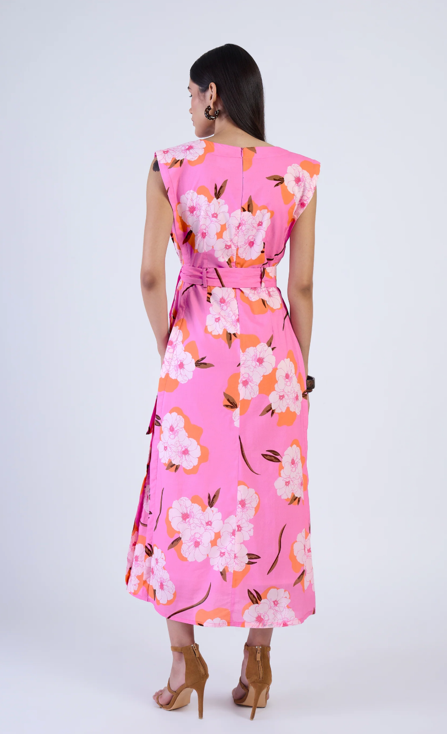 Woman wearing a pink floral dress on a white background