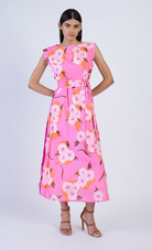 Woman wearing a pink floral dress on a white background