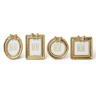 Set of four gold picture frames with decorative elements on a white background