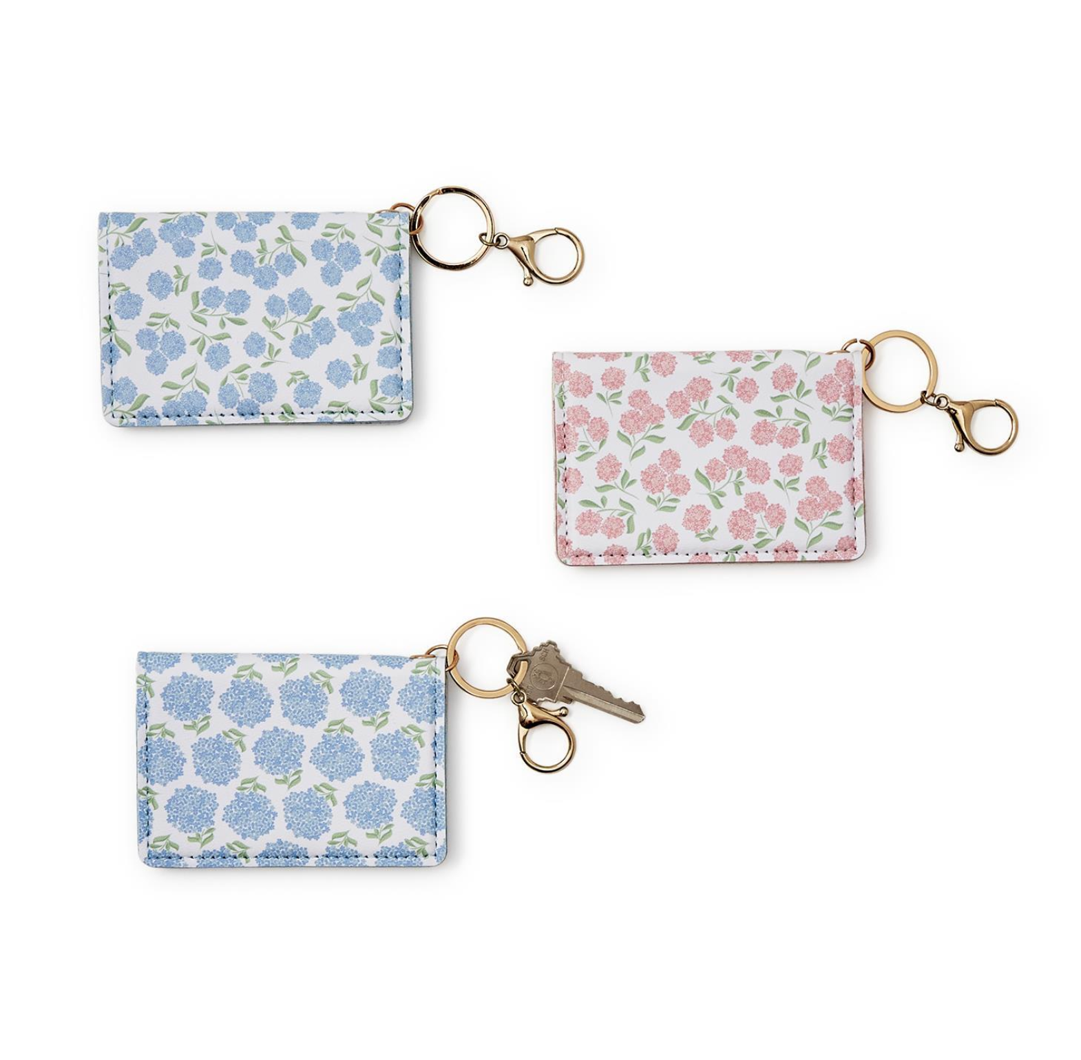 Three floral-patterned keychains on a white background