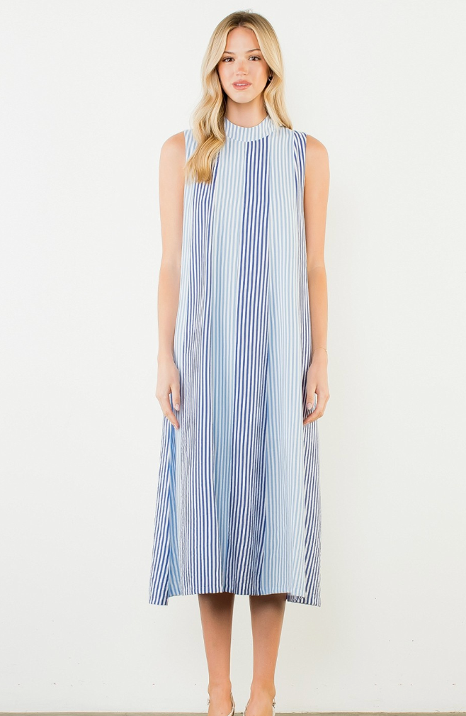 Woman wearing a blue and white striped dress on a white background