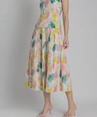 Woman wearing a floral dress on a plain background