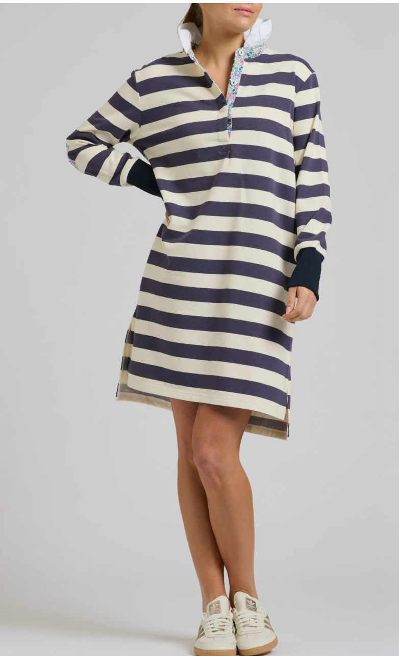 Person wearing a striped dress with a hood on a plain background