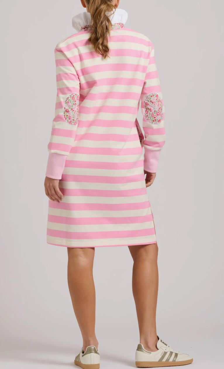 Pink and white striped dress with floral embellishments on a plain background